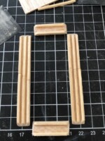 Wood sticks are glued into three lines to create sliding windows. Wood sticks