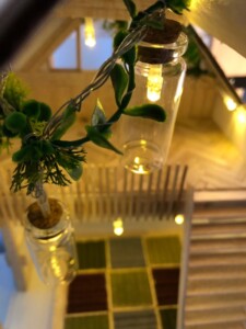 The greenery stuck on light wire adds onto the natural aesthetic of the house and wood materials. The greenery stuck